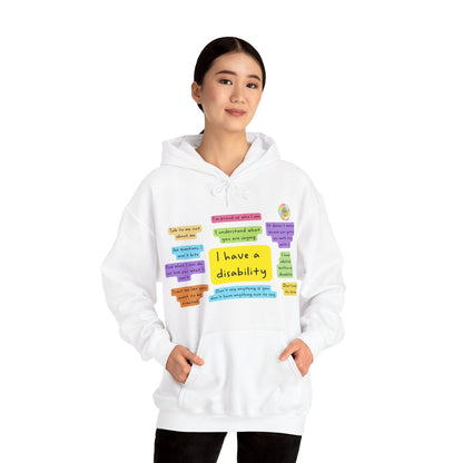 Adult model wearing white I Have a Disability hoodie with colourful front print and R. M. Rayner logo